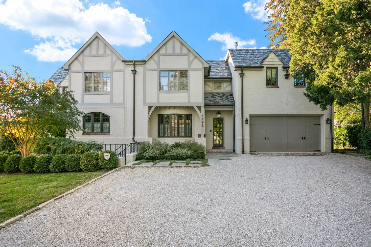 a front view of a house with a yard and garage