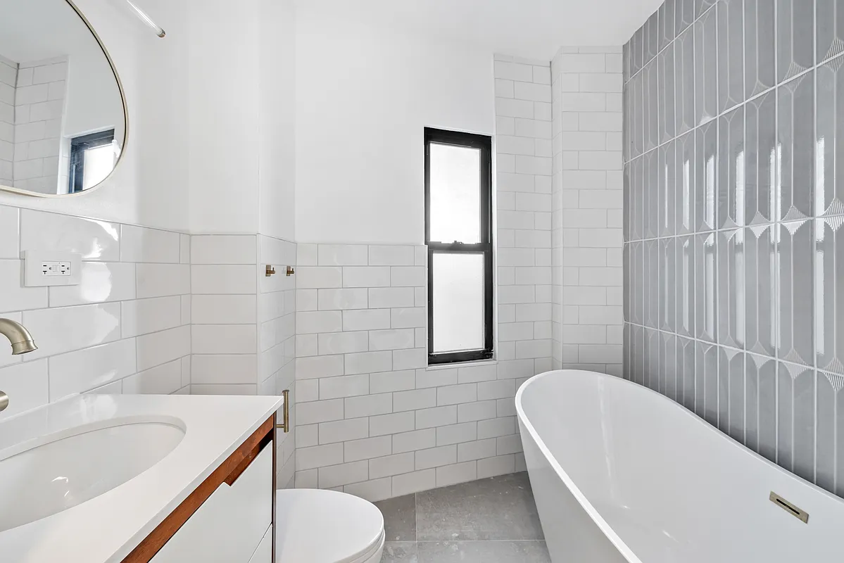 76 Meserole Avenue, Unit 2A Brooklyn, NY 11222 - Photo 5 of 10 a bathroom with a sink a toilet and shower