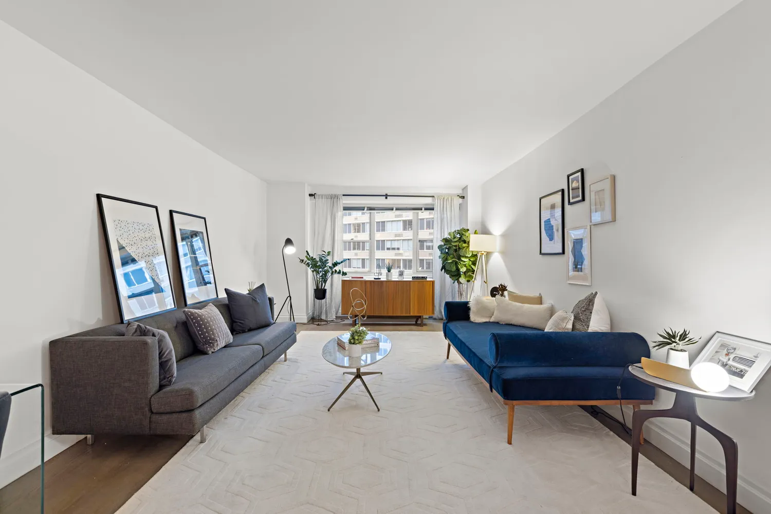 a living room with furniture and a potted plant