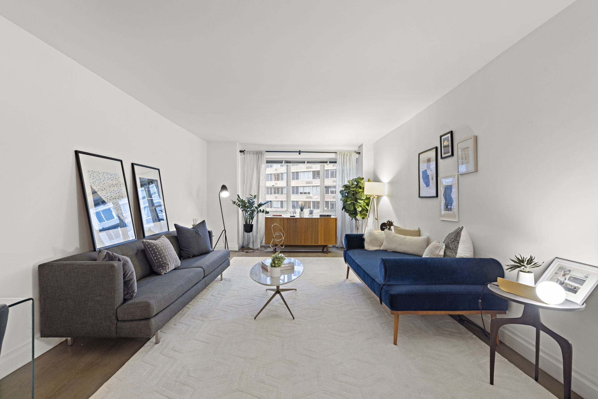 a living room with furniture and a potted plant