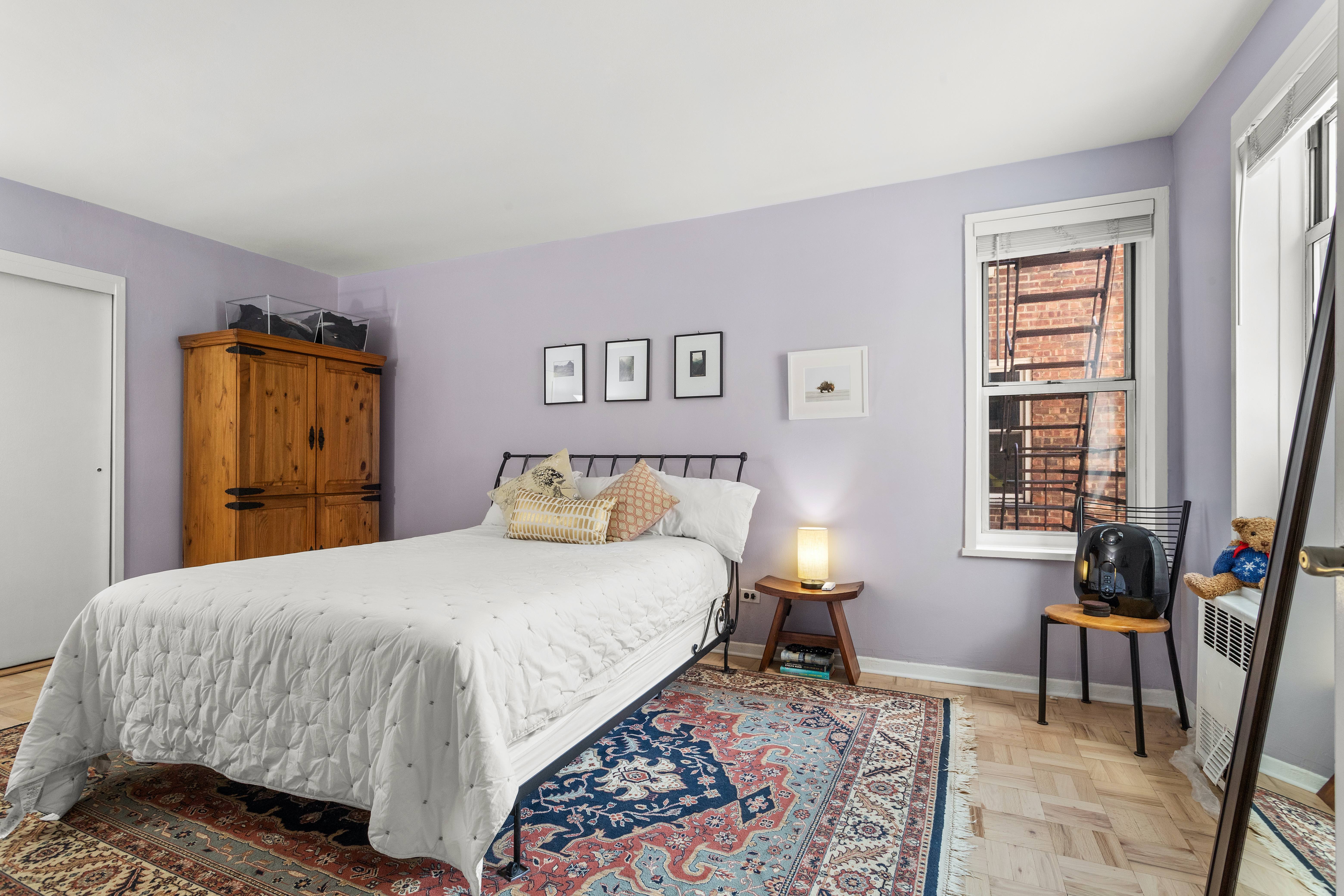 66 Overlook Terrace, Unit 4K Manhattan, NY 10040 - Photo 12 of 26 a bedroom with a bed and wooden floor