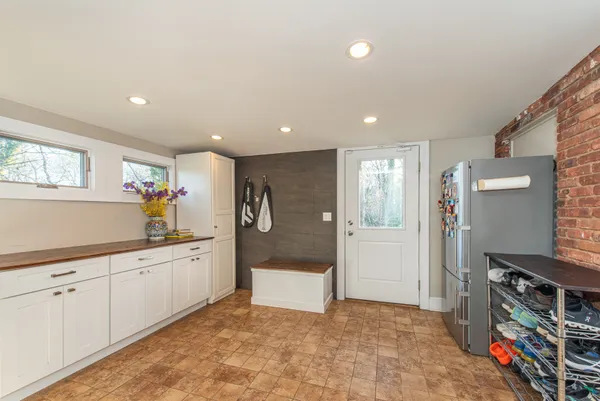 a view of kitchen with stainless steel appliances granite countertop a refrigerator and a sink