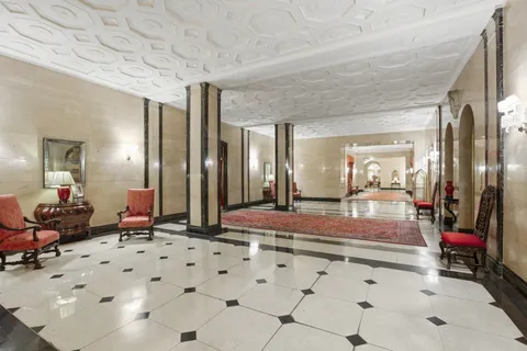 a bedroom with furniture and large mirror