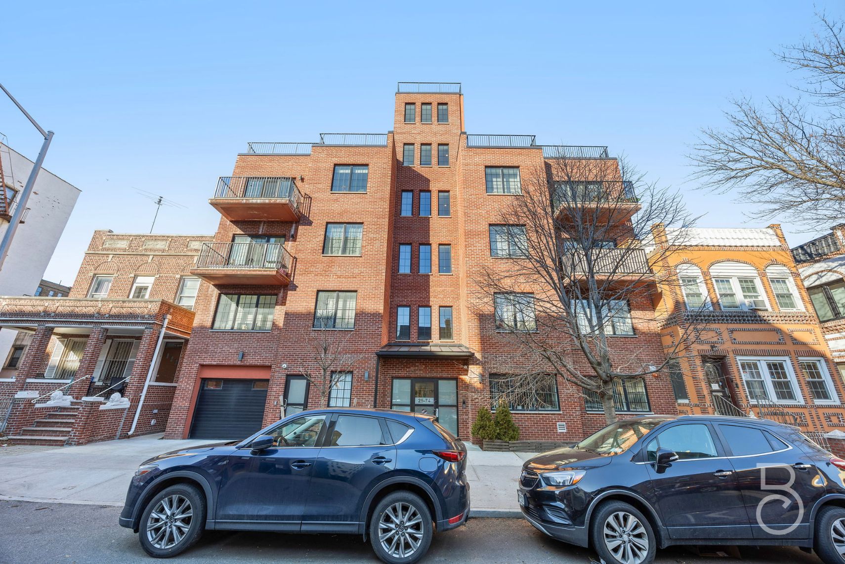 25-74 34th Street, Unit 4C Queens, NY 11103 - Photo 14 of 15 a front view of a residential apartment building with a parking space