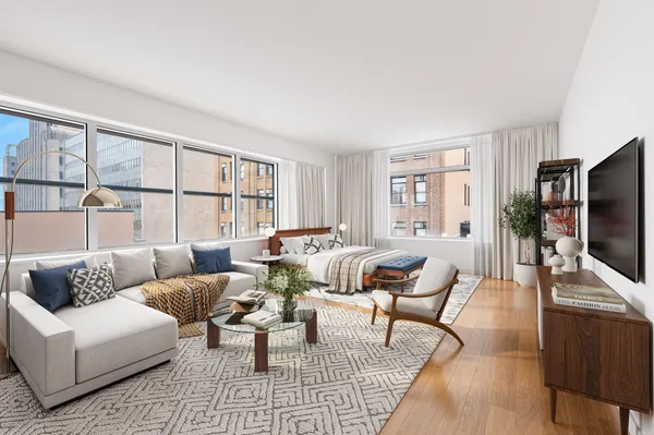 a living room with furniture flat screen tv and a large window