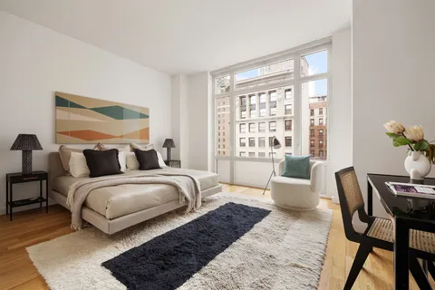 a spacious bedroom with a bed and a couch