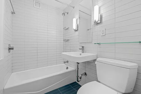 a bathroom with a sink a toilet and bathtub