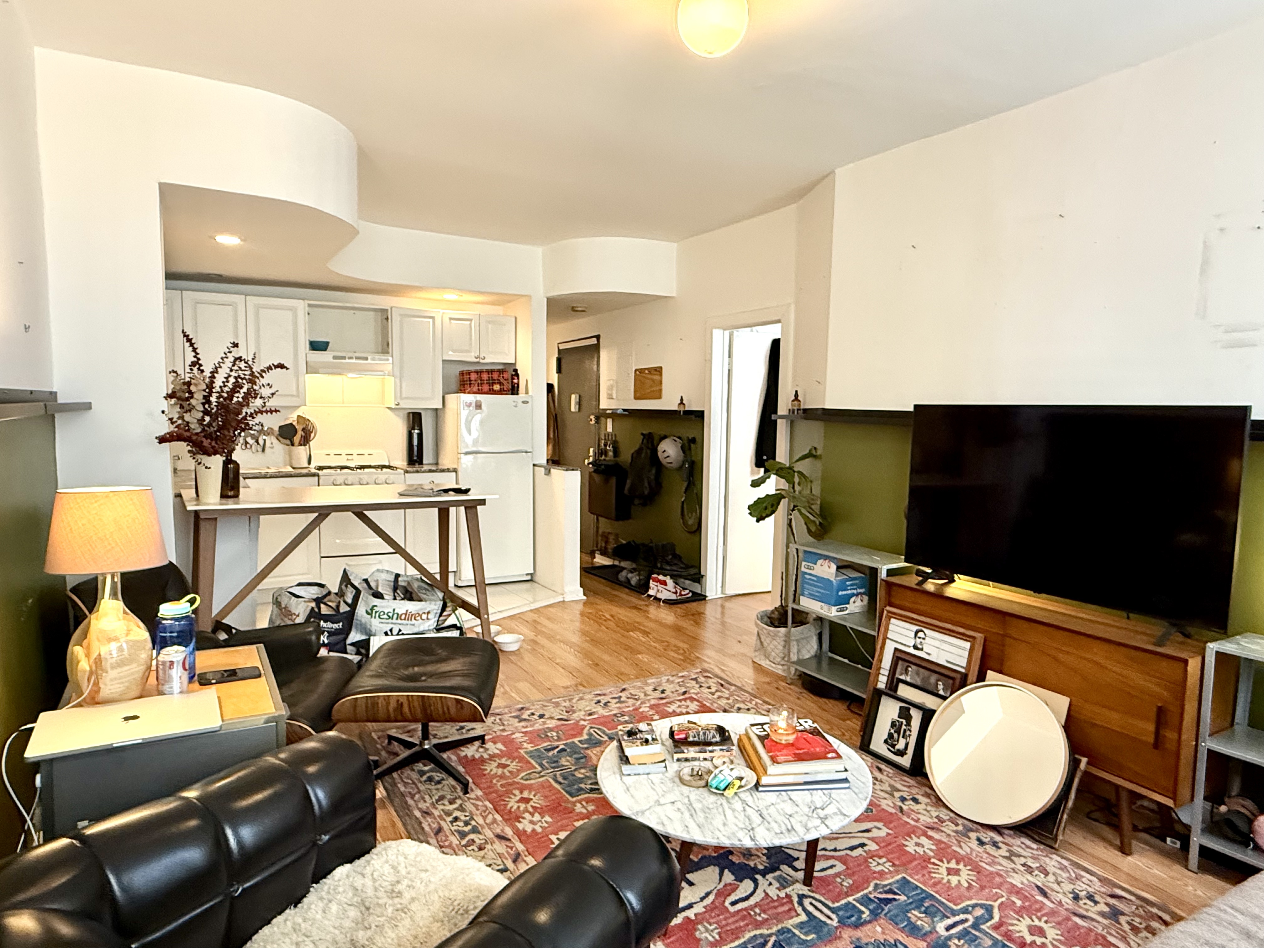 Address Upon Request Manhattan, NY 10029 - Photo 3 of 11 a living room with furniture and a flat screen tv