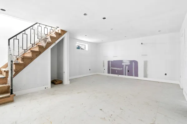 a view of an empty room with stairs