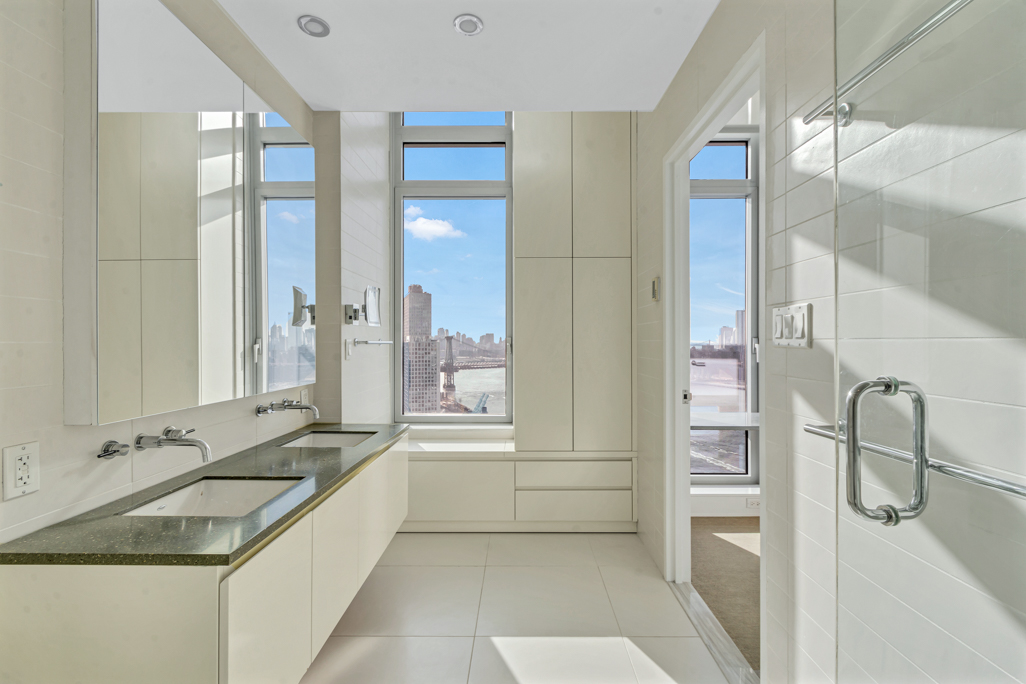 2 Northside Piers, Unit PH2 Brooklyn, NY 11249 - Photo 17 of 27 a bathroom with a granite countertop sink and a mirror