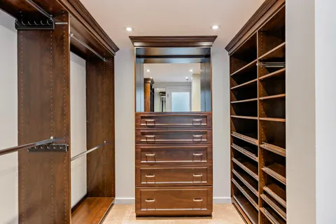 a view of walk in closet and bedroom view