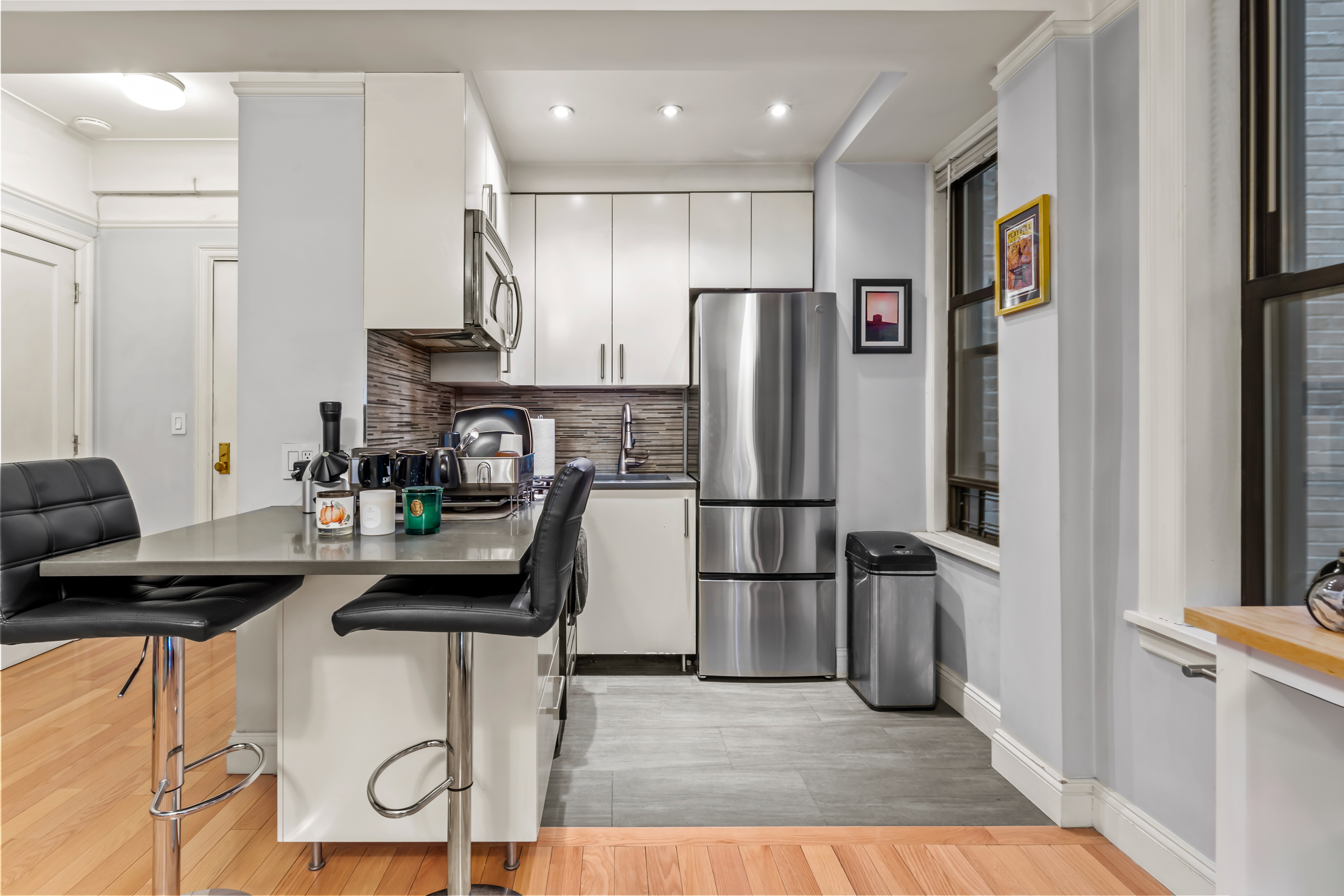 467 Central Park West, Unit 2G Manhattan, NY 10025 - Photo 1 of 10 a kitchen with stainless steel appliances a refrigerator and a stove top oven