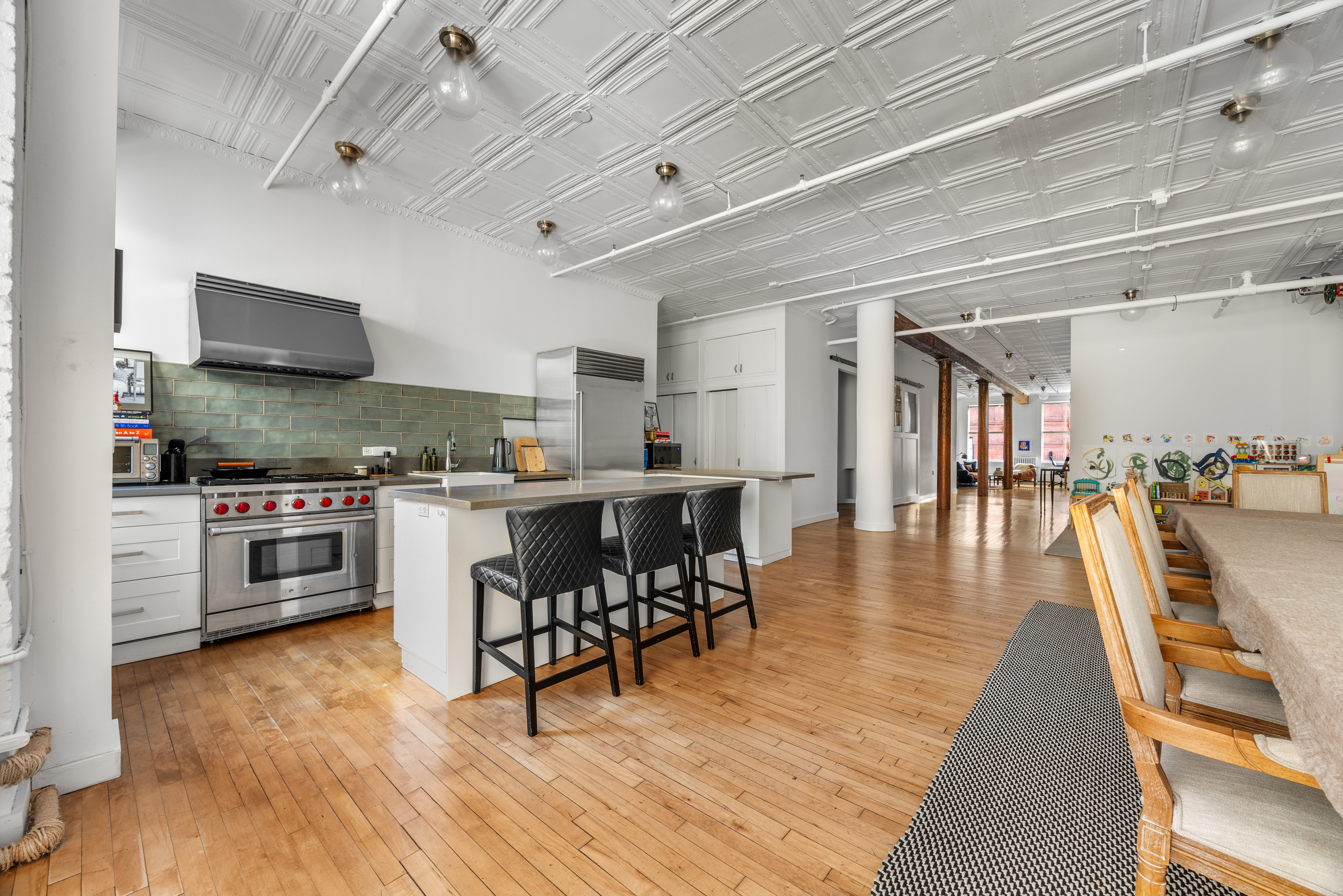 5 White Street, Unit 5B Manhattan, NY 10013 - Photo 4 of 21 a kitchen with stainless steel appliances a stove a sink dishwasher a refrigerator and white cabinets with wooden floor