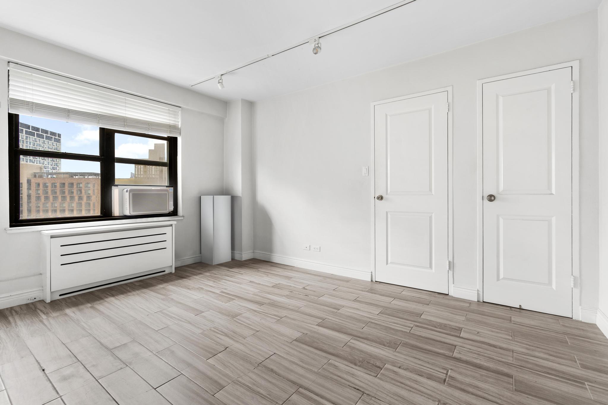 266 East Broadway, Unit 1304B Manhattan, NY 10002 - Photo 5 of 8 a view of an empty room with a window