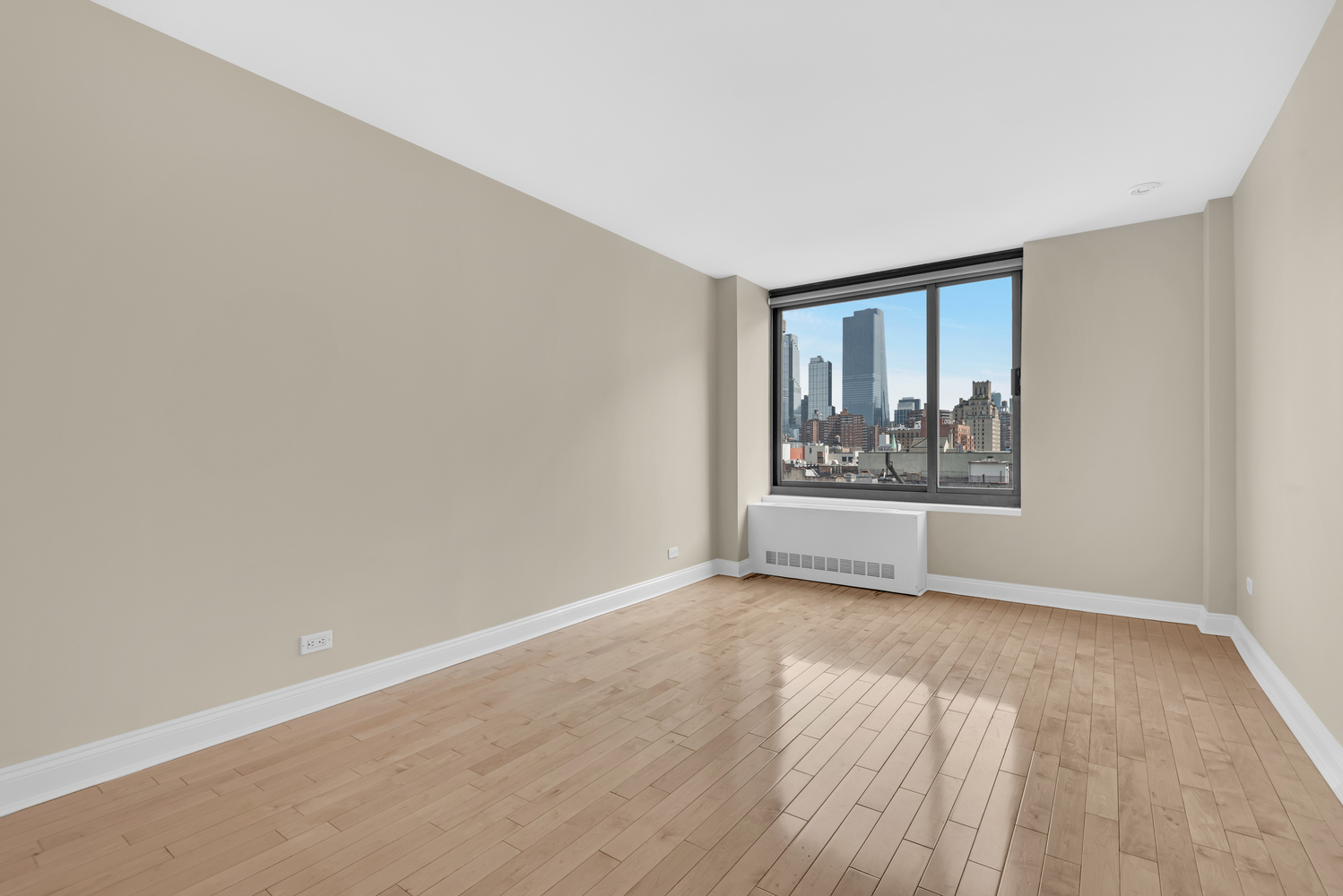 270 West 17th Street, Unit 8B Manhattan, NY 10011 - Photo 4 of 6 wooden floor in an empty room with a window