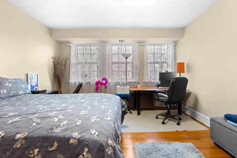 a view of a workspace with furniture and a window