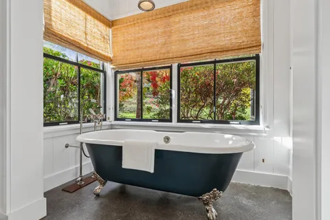 a white stove sitting in a kitchen next to a window
