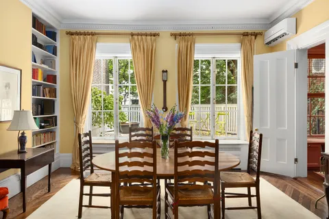 a view of a dining room with furniture and a window
