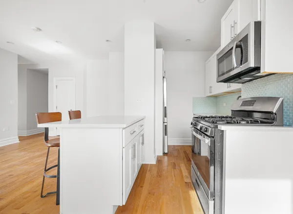 a kitchen with a stove and a refrigerator