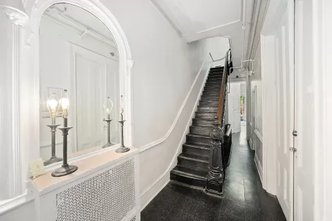 a living room with furniture a large window and a chandelier