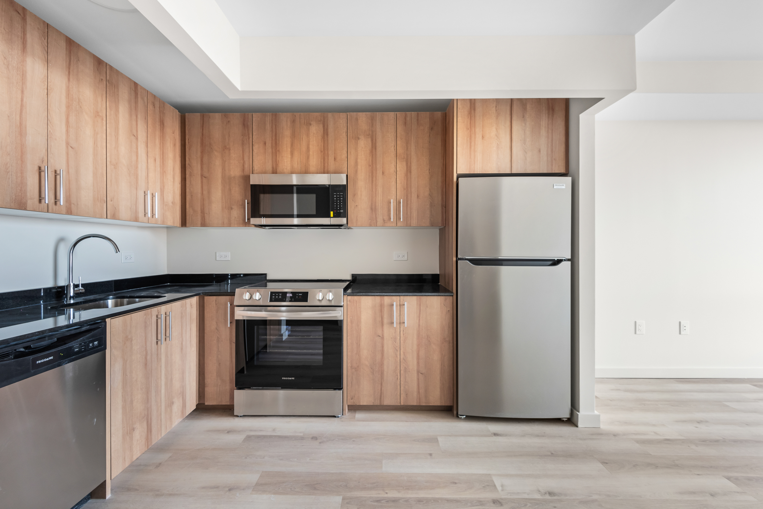 1333 Broadway, Unit 605 Brooklyn, NY 11221 - Photo 2 of 11 a kitchen with a refrigerator sink and microwave