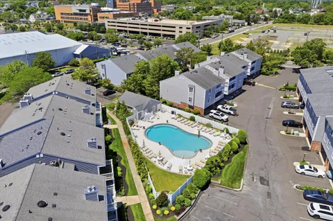 an aerial view of a house with a swimming pool