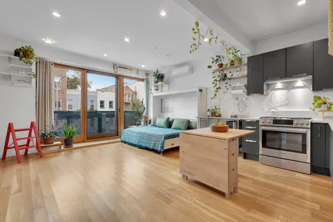 a kitchen with stainless steel appliances granite countertop a stove and a wooden floors