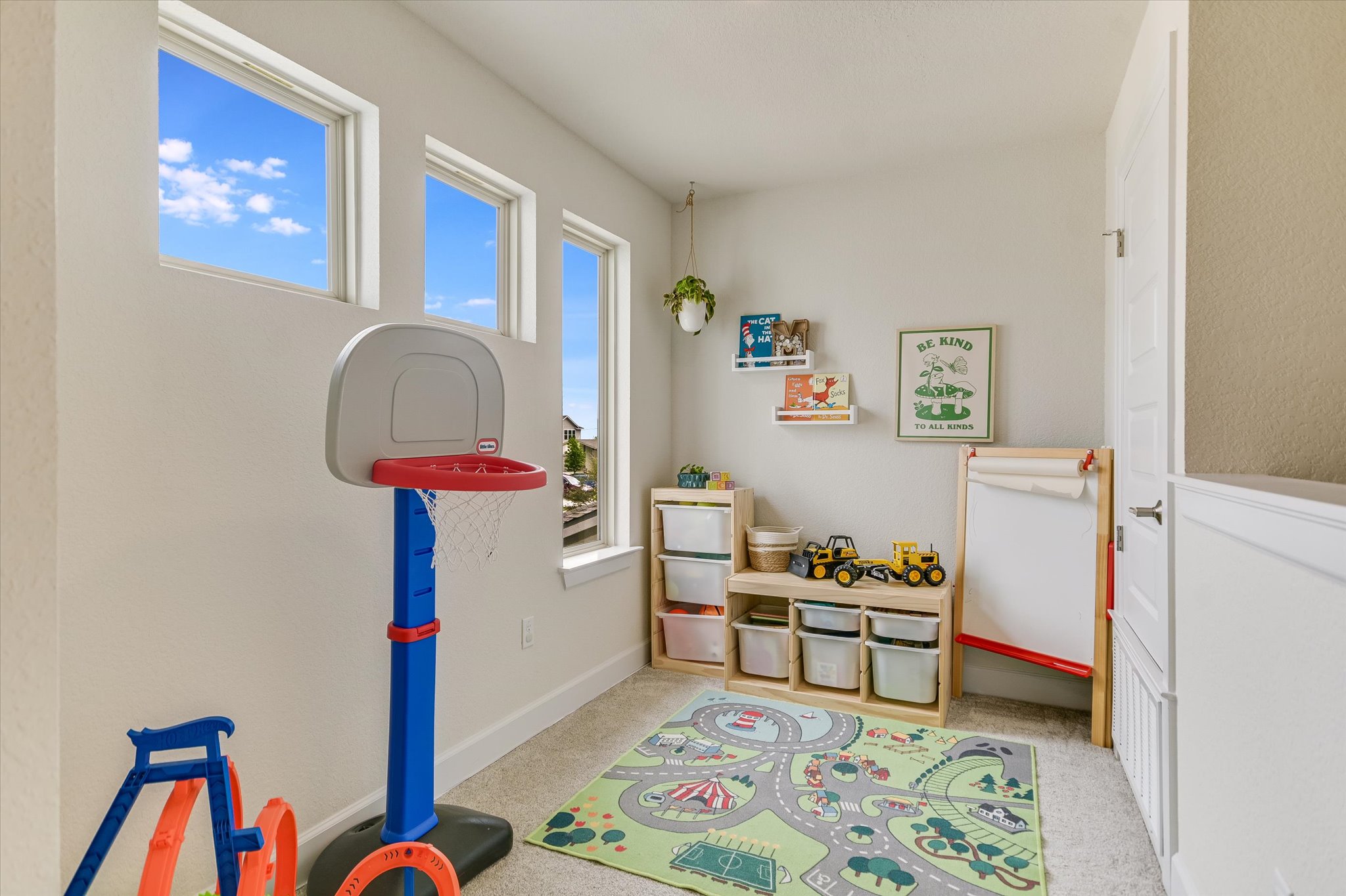8607 McKamy Drive Austin, TX 78744 - Photo 14 of 28 a bedroom with furniture and a book shelf