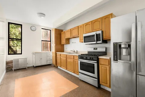 a kitchen with stainless steel appliances a stove a microwave and a refrigerator