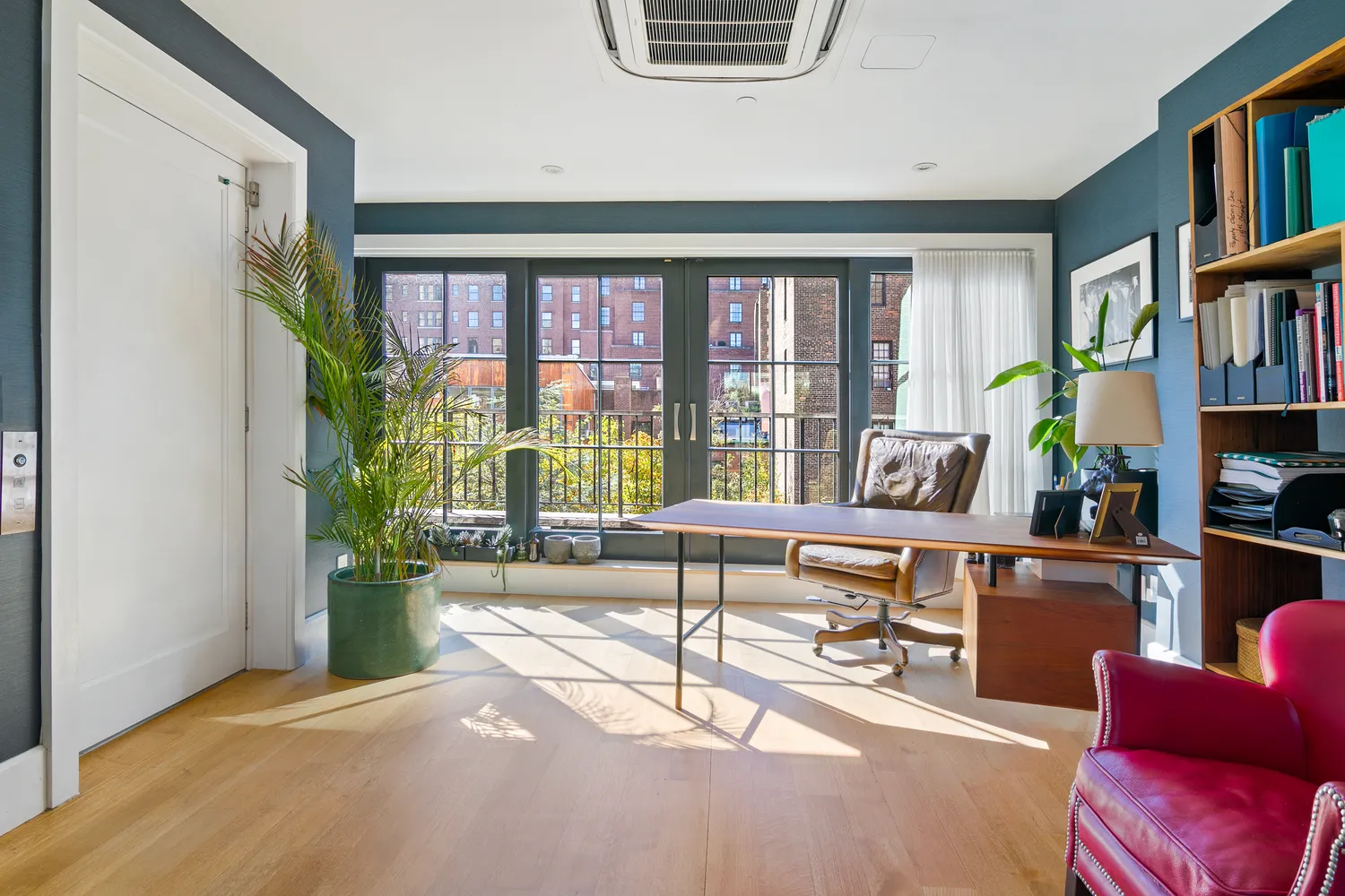 a living room with furniture and a book shelf