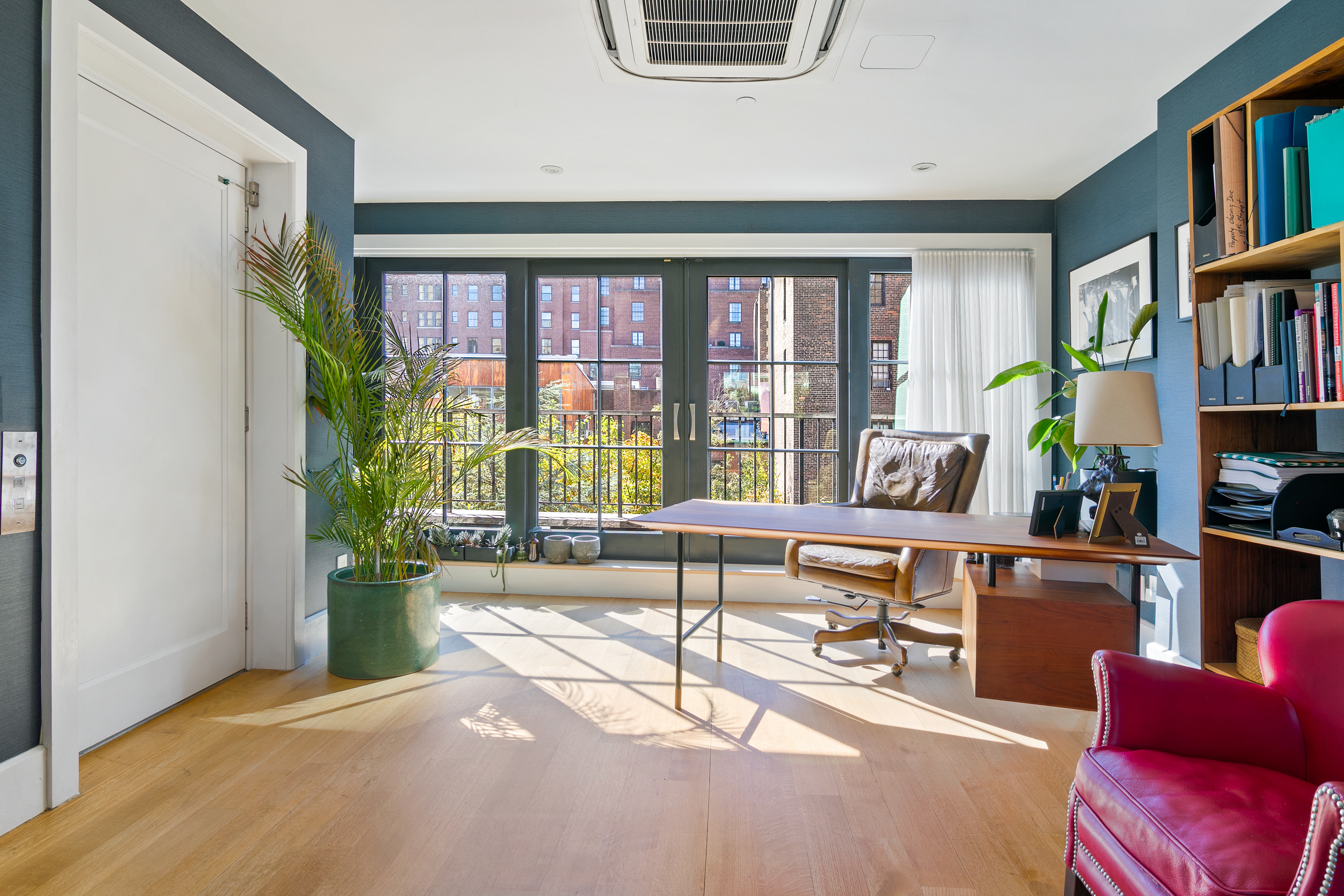 152 West 13th Street Manhattan, NY 10011 - Photo 25 of 28 a living room with furniture and a book shelf