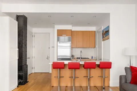 a table and chair sitting in a room next to a window