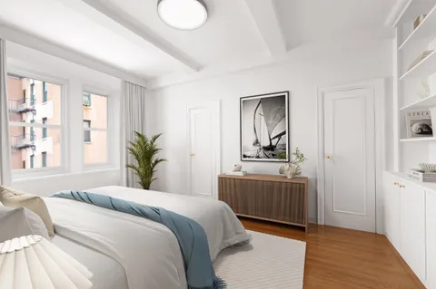 a bedroom with a large bed and a window