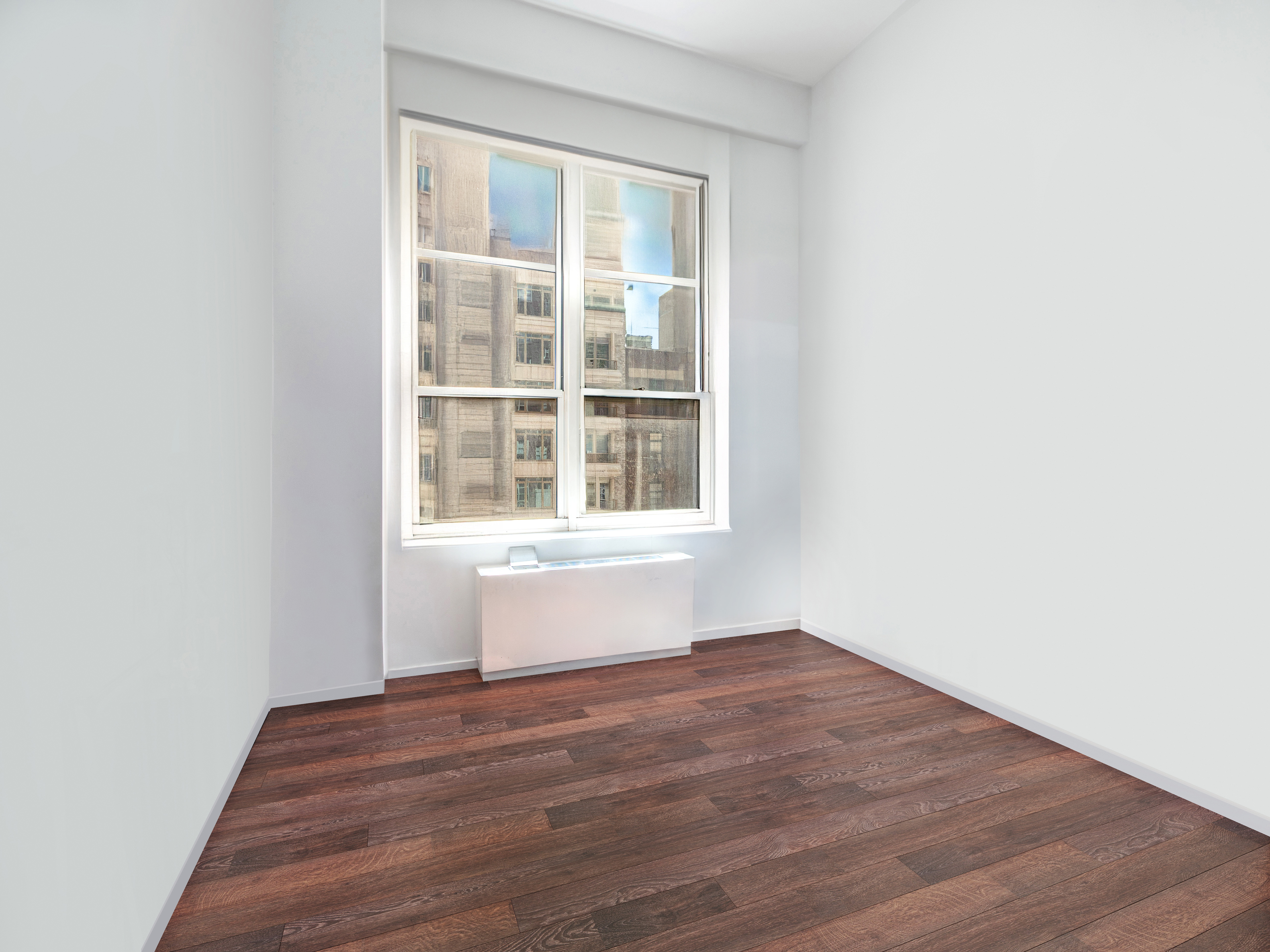 120 East 87th Street, Unit R6IJ Manhattan, NY 10128 - Photo 10 of 27 a view of empty room with wooden floor and fan