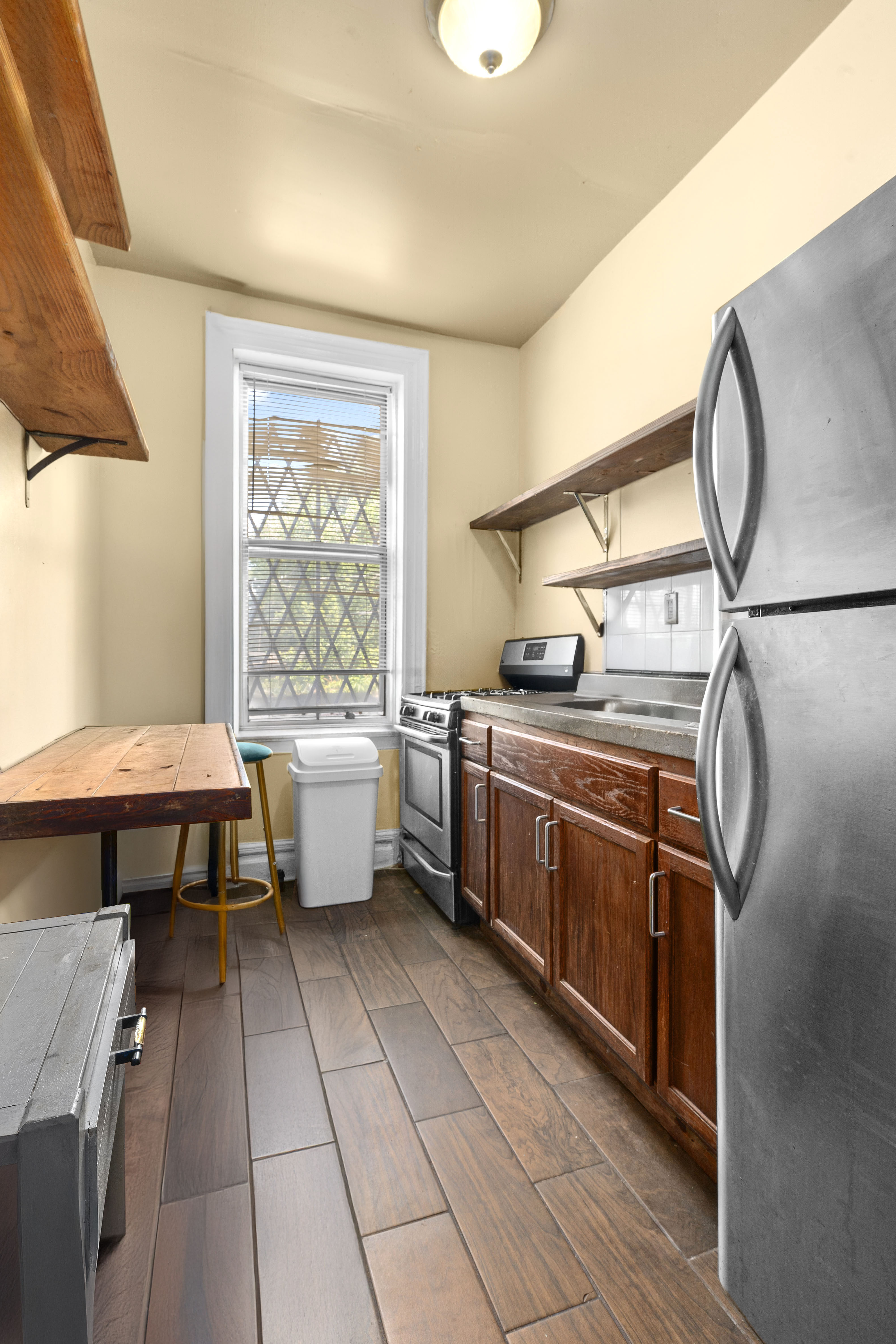 147 Schenectady Avenue Brooklyn, NY 11213 - Photo 6 of 9 a kitchen with stainless steel appliances granite countertop a sink and a stove