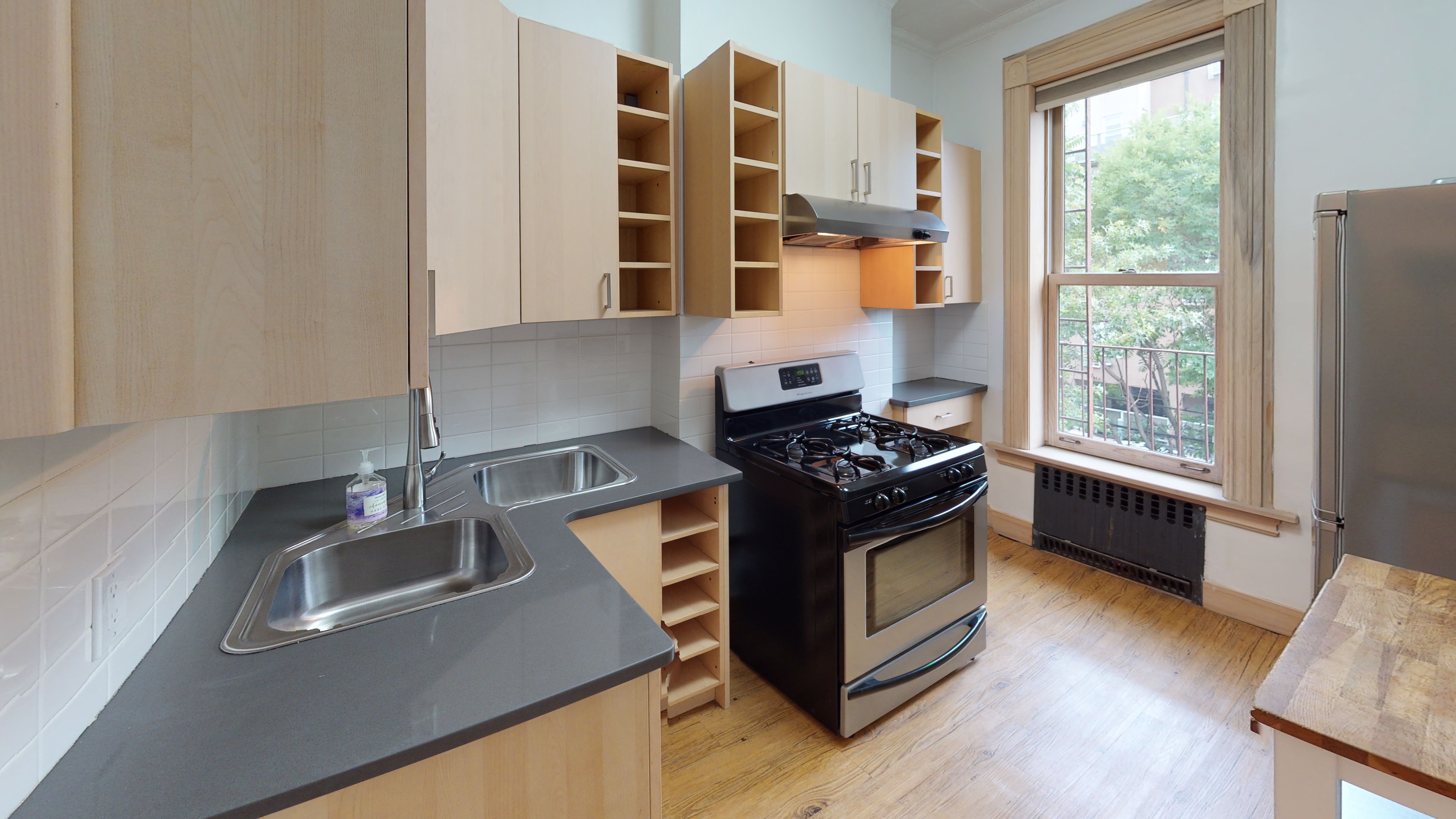 332 15th Street, Unit 3 Brooklyn, NY 11215 - Photo 4 of 8 a kitchen with granite countertop a stove and a sink