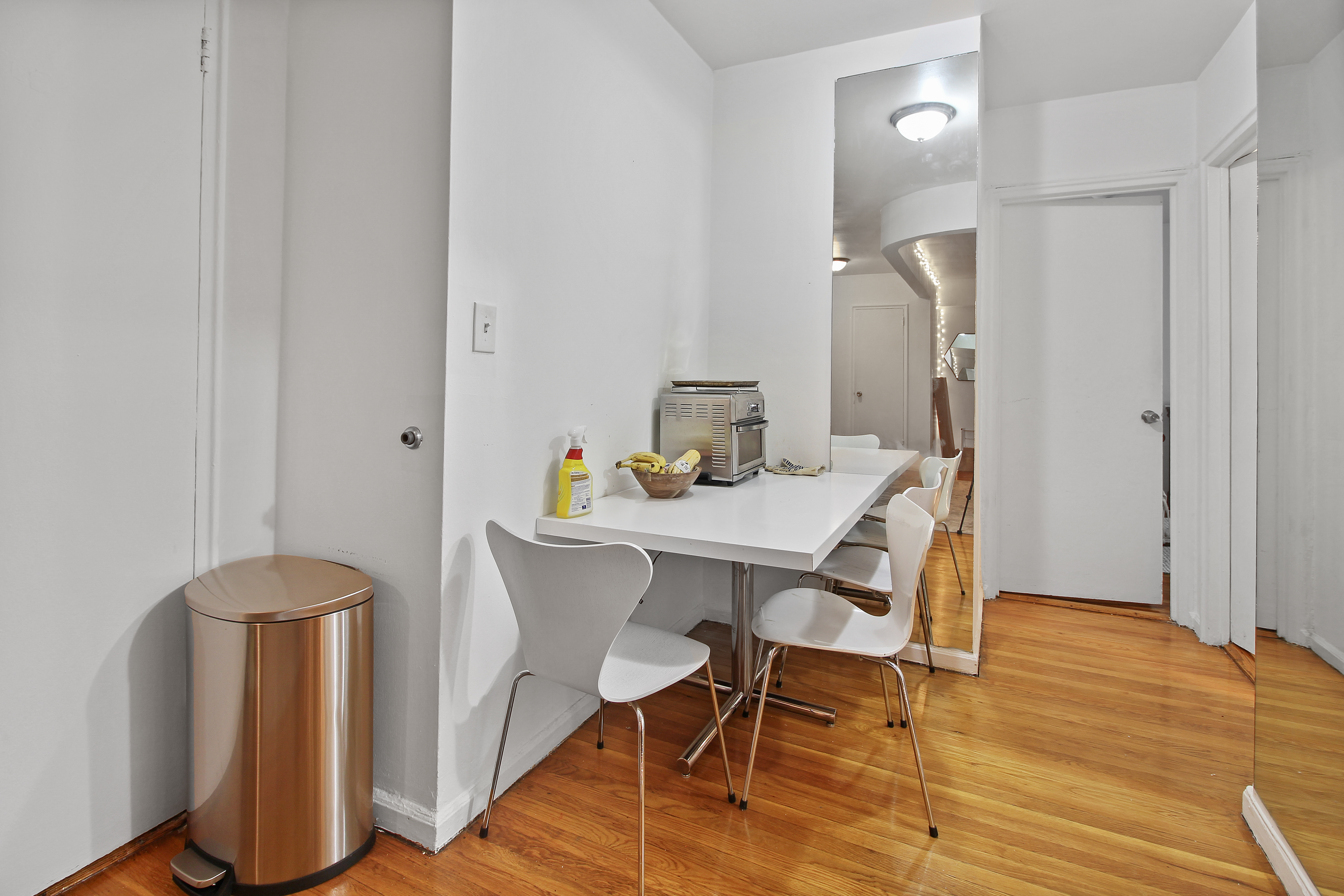 315 East 56th Street, Unit 5F Manhattan, NY 10022 - Photo 3 of 9 a view of a dining room with furniture and wooden floor
