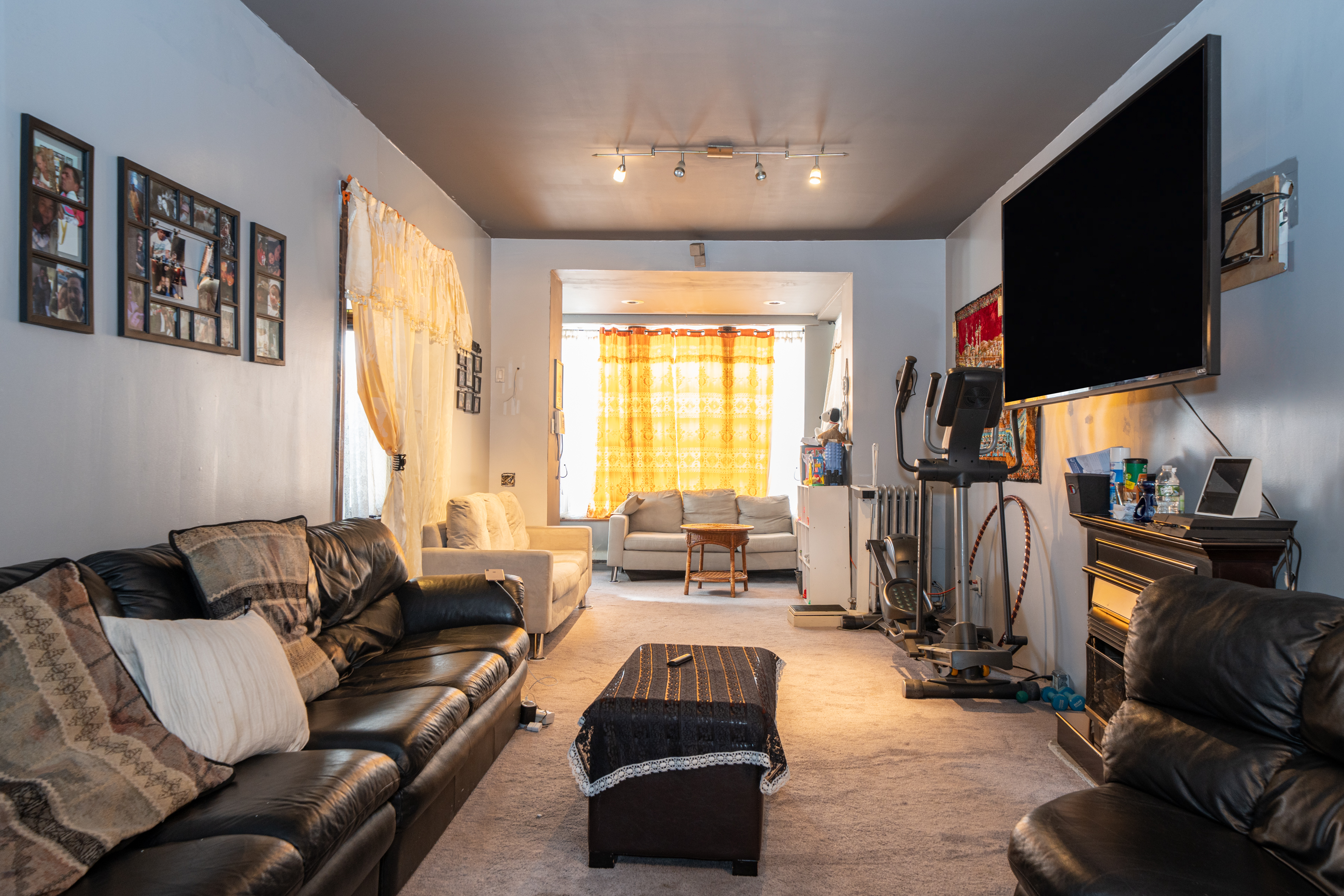 415 84th Street Brooklyn, NY 11209 - Photo 4 of 17 a living room with furniture and a flat screen tv