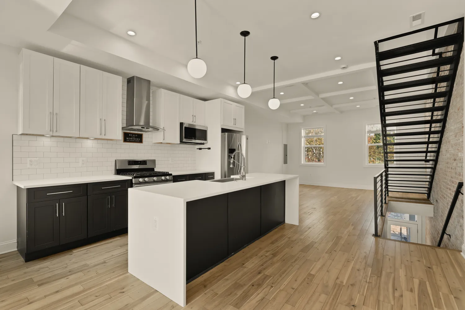 a kitchen with kitchen island a sink and a stove top oven