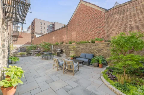a view of a terrace with chairs and potted plants