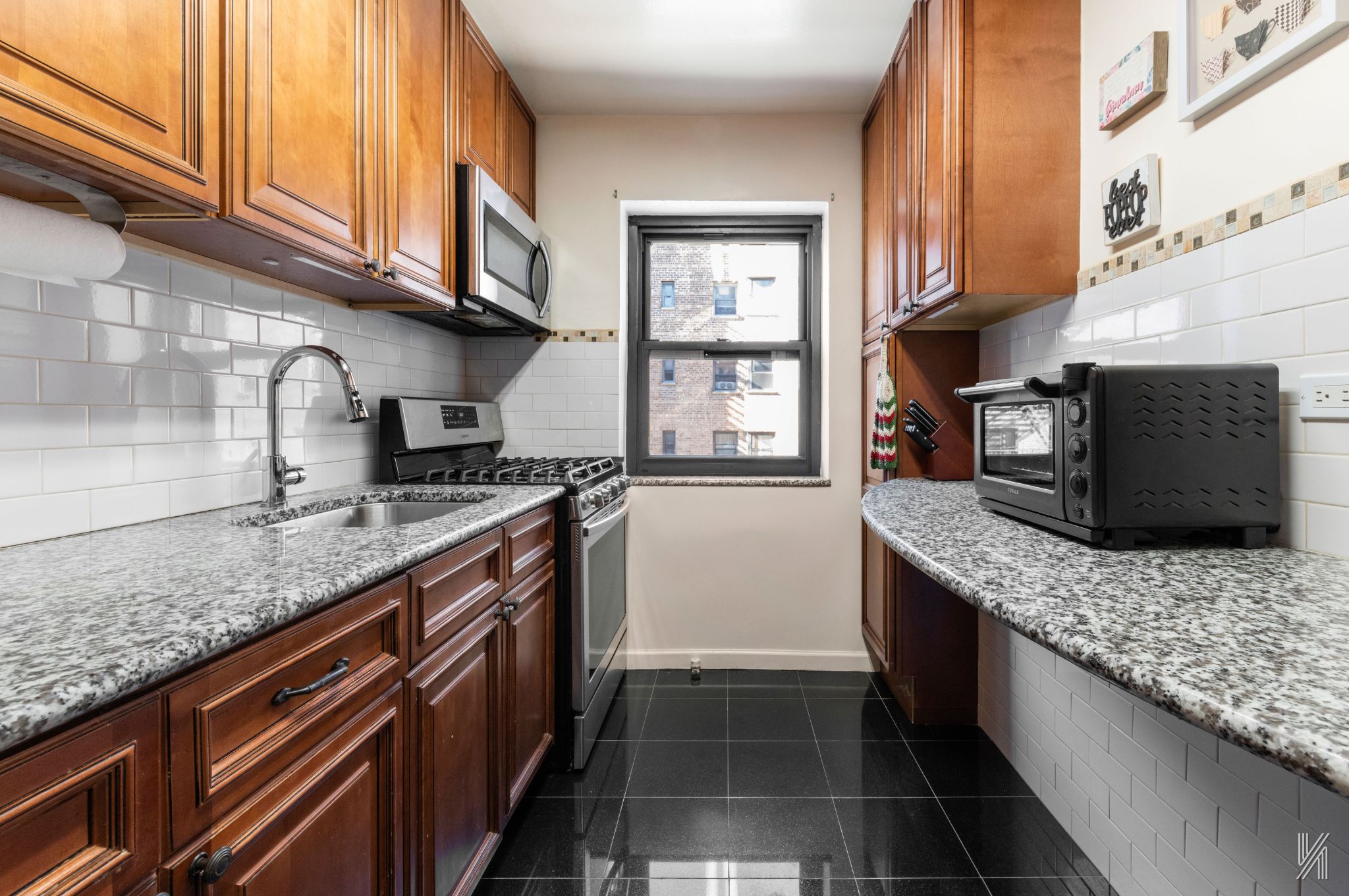 a kitchen with stainless steel appliances granite countertop a sink stove and cabinets