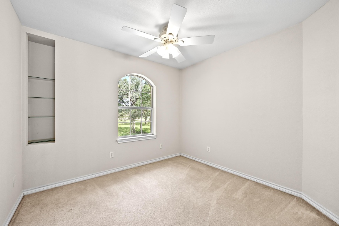 111 Trinity Street Cedar Creek, TX 78612 - Photo 22 of 38 an empty room with windows and fan