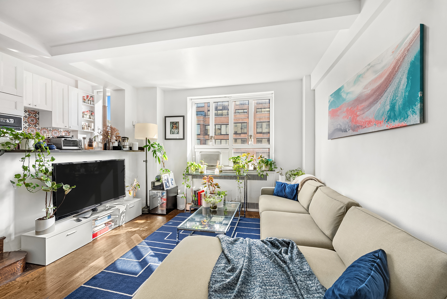 200 West 20th Street, Unit 905 Manhattan, NY 10011 - Photo 5 of 17 a living room with furniture large window and flat screen tv