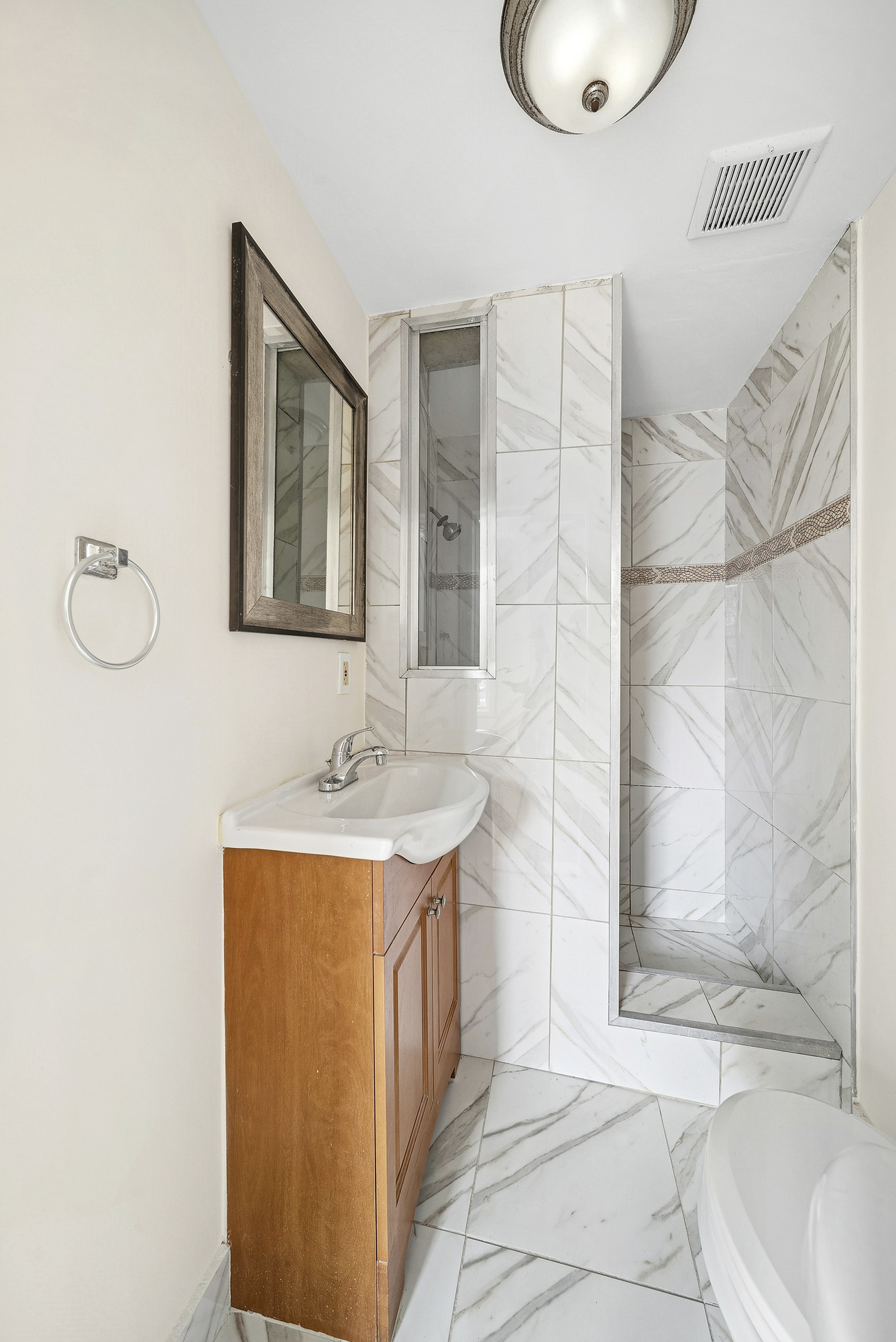 109 Moffat Street, Unit 2F Brooklyn, NY 11207 - Photo 8 of 8 a bathroom with a sink a toilet and shower