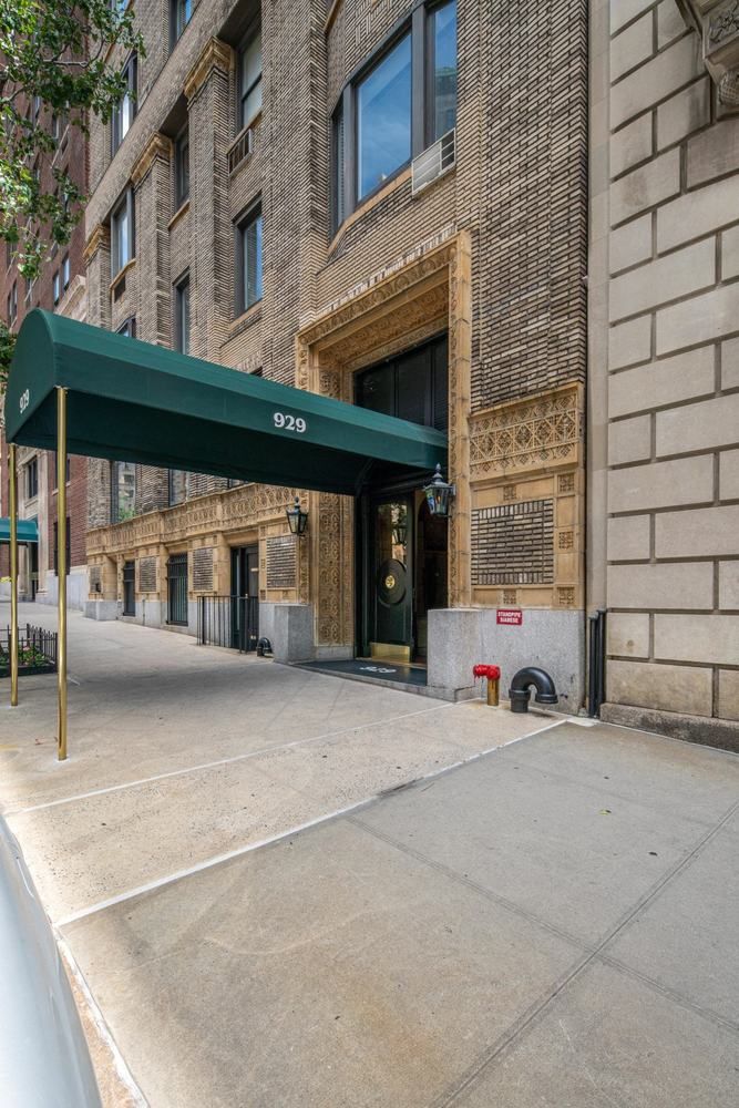 929 Park Avenue, Unit 6C Manhattan, NY 10028 - Photo 8 of 10 a building with car parked in front of it