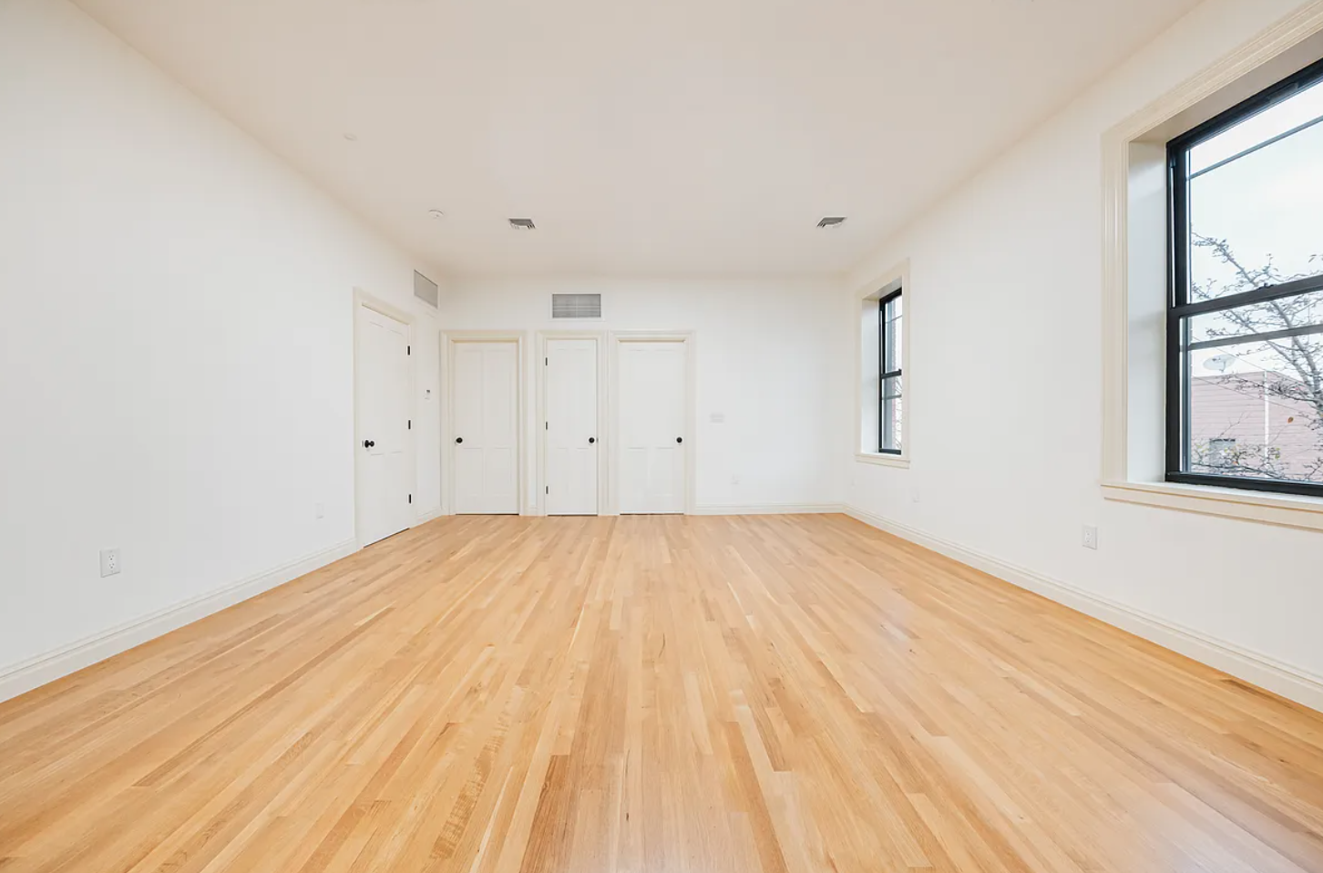 68-38 Forest Avenue, Unit 3R Queens, NY 11385 - Photo 8 of 15 a view of empty room with wooden floor and fan