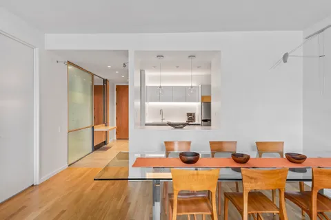 a living room with dining room and wooden floor