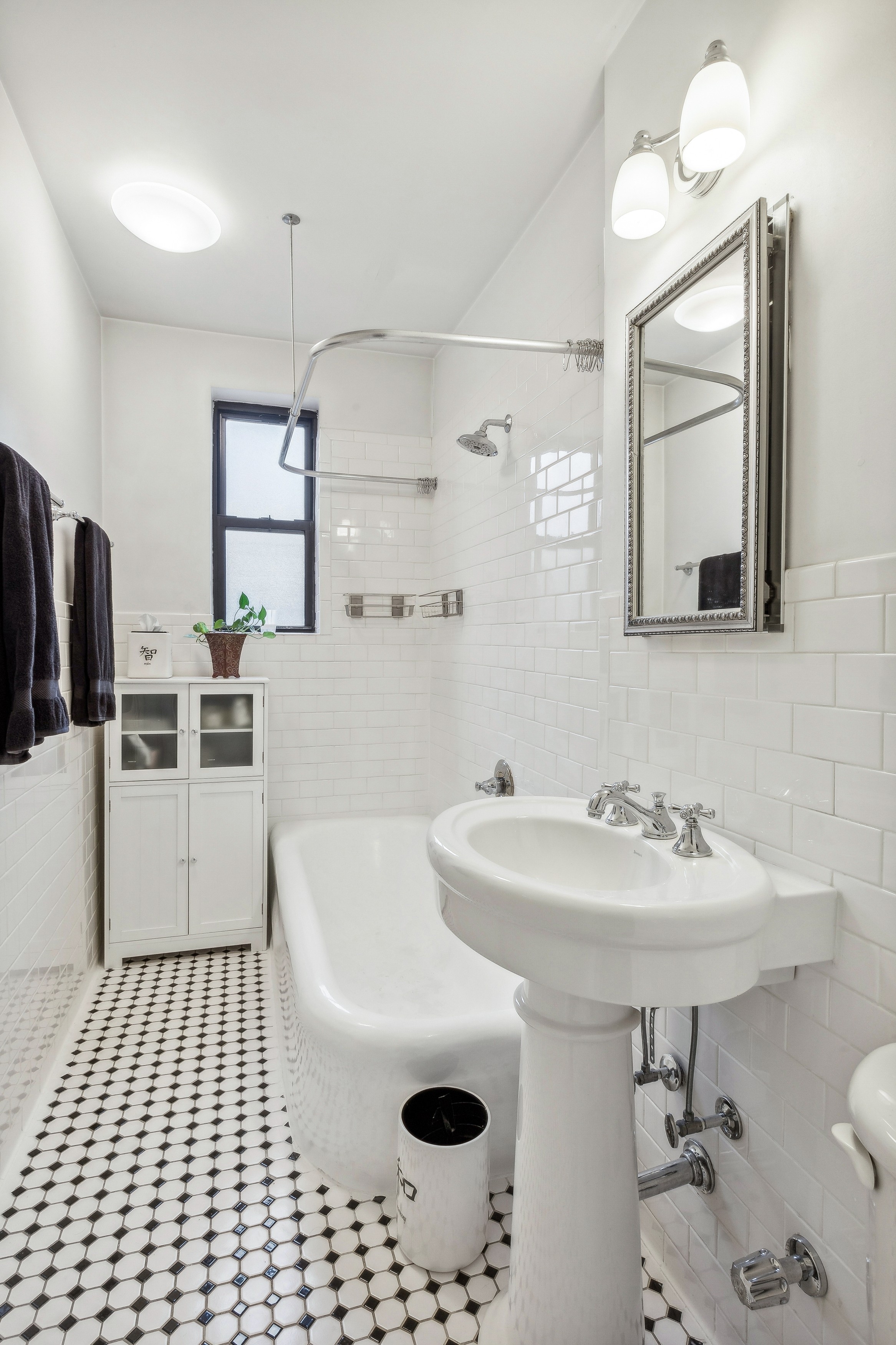 779 Riverside Drive, Unit C31 Manhattan, NY 10032 - Photo 8 of 13 a bathroom with a sink a mirror and a shower