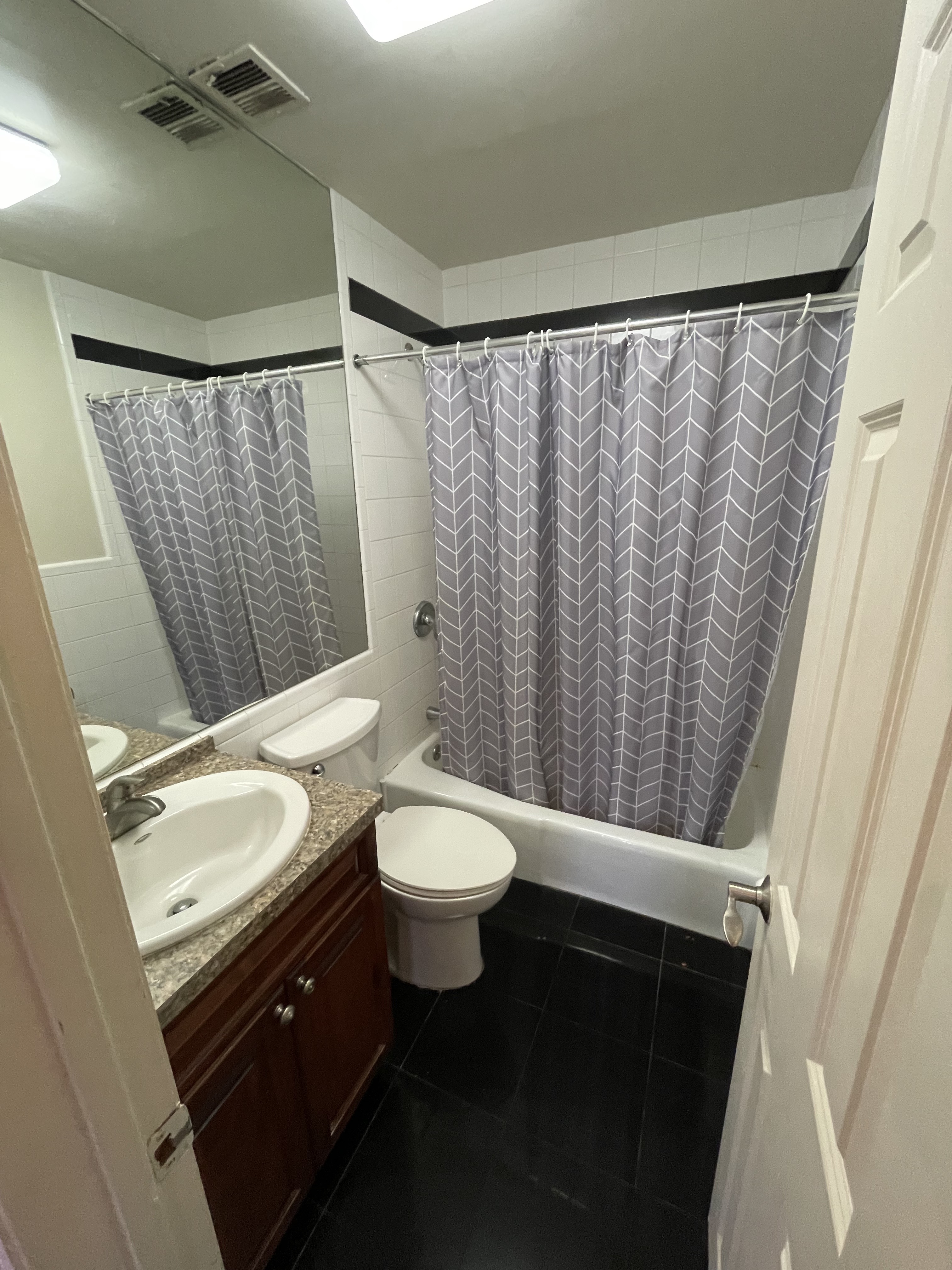 91 Hanson Place, Unit 2A Brooklyn, NY 11217 - Photo 4 of 4 a bathroom with a granite countertop sink toilet and shower