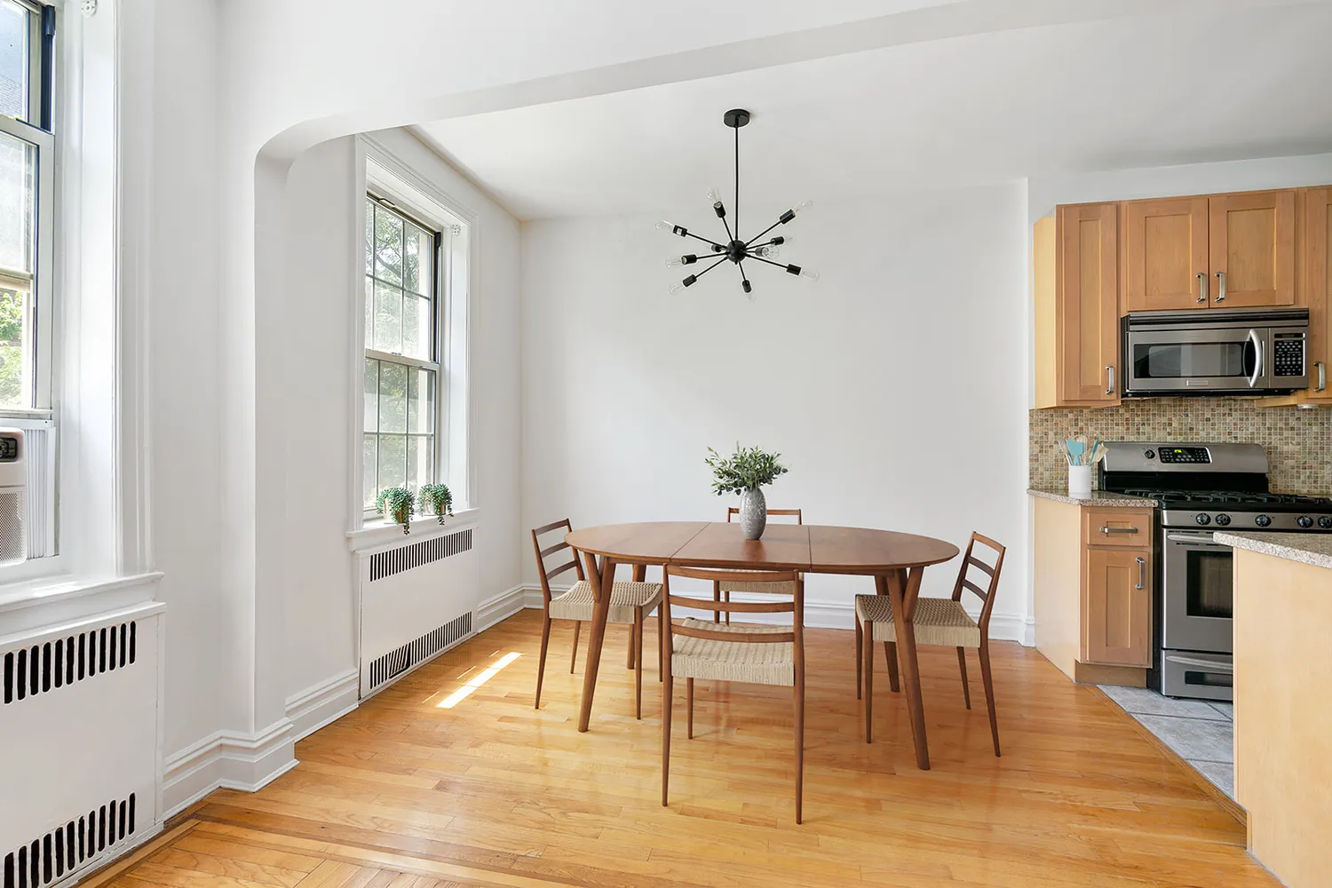 a view of a dining room with furniture window and wooden floor